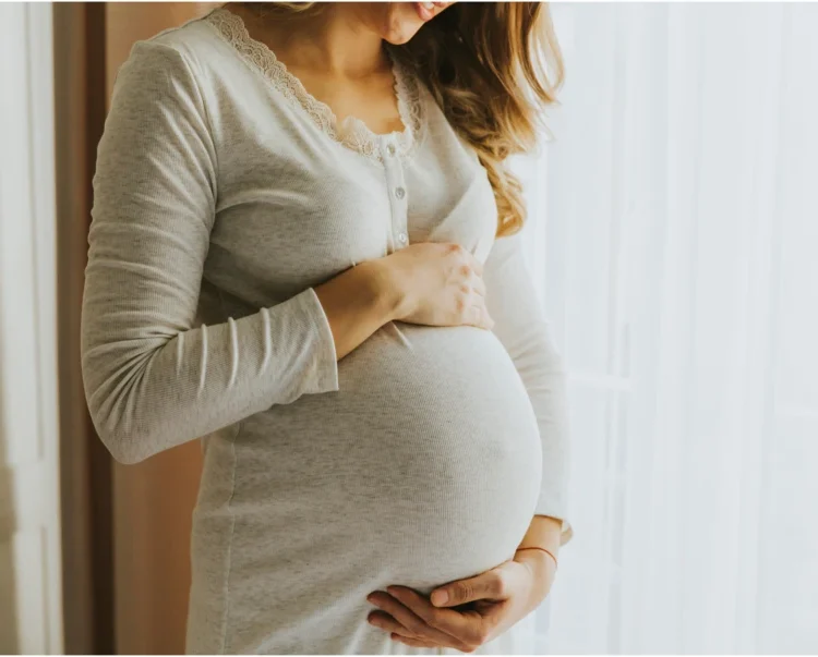 Pregnant woman holding stomach